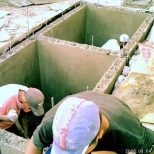 Workers building the foundation of a church